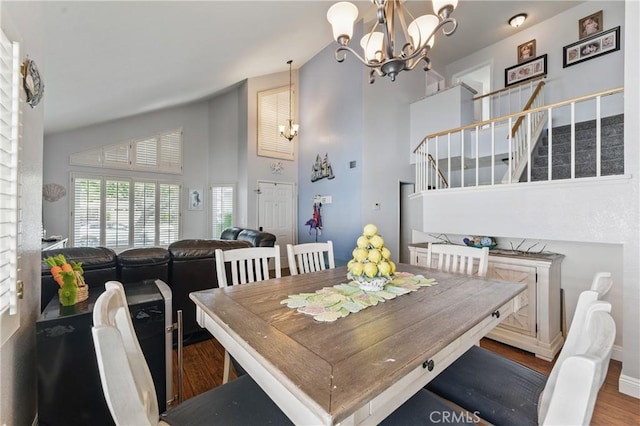 3140 Timberline Dr, Corona, CA 92882 - dining space featuring a chandelier, stairs, high vaulted ceiling, and wood finished floors