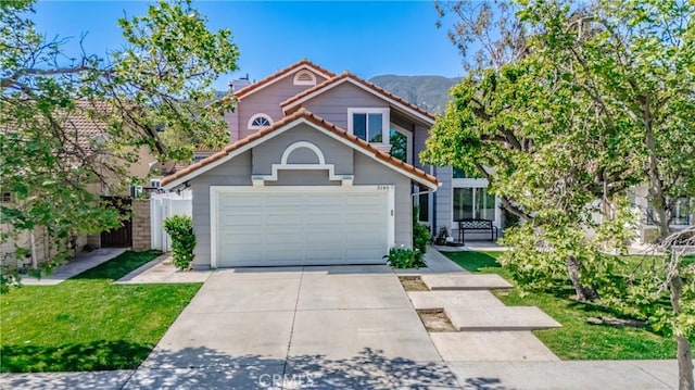 3140 Timberline Dr, Corona, CA 92882 - view of front facade with a tiled roof, a garage, a front lawn, a mountain view, and driveway
