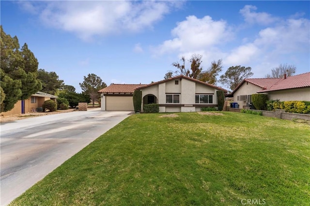 mediterranean / spanish house featuring stucco siding, an attached garage, driveway, and a front lawn