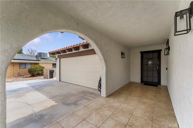 doorway to property featuring central AC and stucco siding