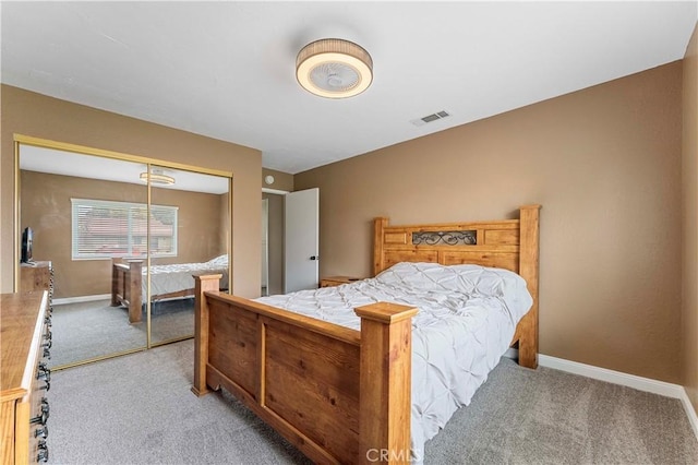 carpeted bedroom featuring baseboards, visible vents, and a closet