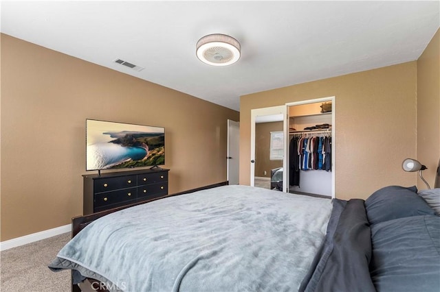 carpeted bedroom featuring visible vents, baseboards, and a closet