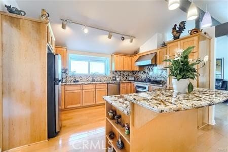 21651 Yucatan Ave, Woodland Hills, CA 91364 - kitchen with stainless steel appliances, wall chimney range hood, light wood-style floors, light brown cabinetry, and track lighting