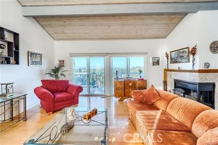 21651 Yucatan Ave, Woodland Hills, CA 91364 - living area featuring wood finished floors, a fireplace, vaulted ceiling, and wood ceiling