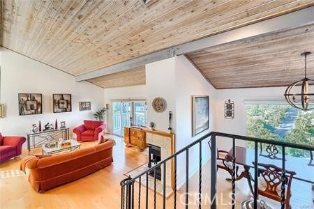 21651 Yucatan Ave, Woodland Hills, CA 91364 - living room with wooden ceiling, vaulted ceiling, wood finished floors, and a chandelier