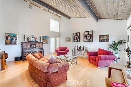 21651 Yucatan Ave, Woodland Hills, CA 91364 - living room with wood finished floors, a high ceiling, and beam ceiling