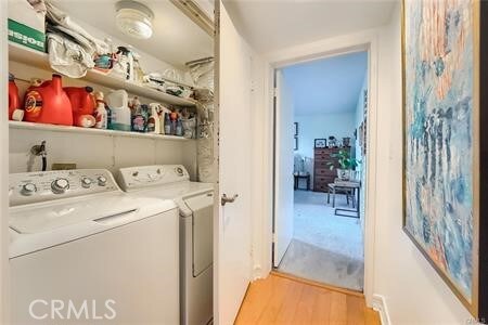 21651 Yucatan Ave, Woodland Hills, CA 91364 - laundry area with washer and clothes dryer and light wood-style flooring