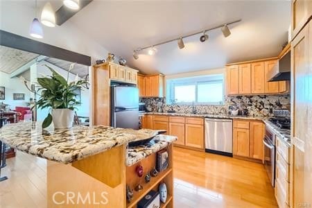 21651 Yucatan Ave, Woodland Hills, CA 91364 - kitchen featuring appliances with stainless steel finishes, light brown cabinets, light wood-style flooring, track lighting, and tasteful backsplash