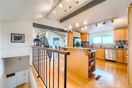 21651 Yucatan Ave, Woodland Hills, CA 91364 - kitchen featuring stainless steel dishwasher, track lighting, light wood finished floors, and backsplash