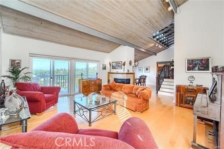 21651 Yucatan Ave, Woodland Hills, CA 91364 - living area featuring vaulted ceiling, wood finished floors, wood ceiling, and a fireplace