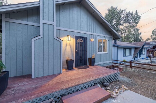 196 Sunset Ln, Sugarloaf, CA 92386 - back of property at dusk featuring a wooden deck