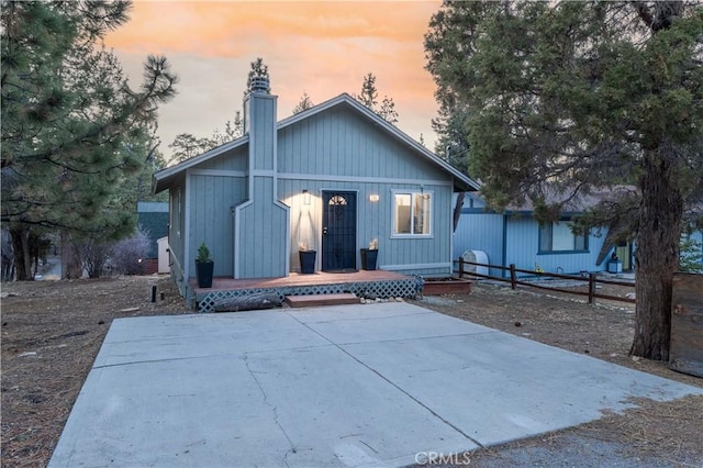 196 Sunset Ln, Sugarloaf, CA 92386 - back of house at dusk with a chimney