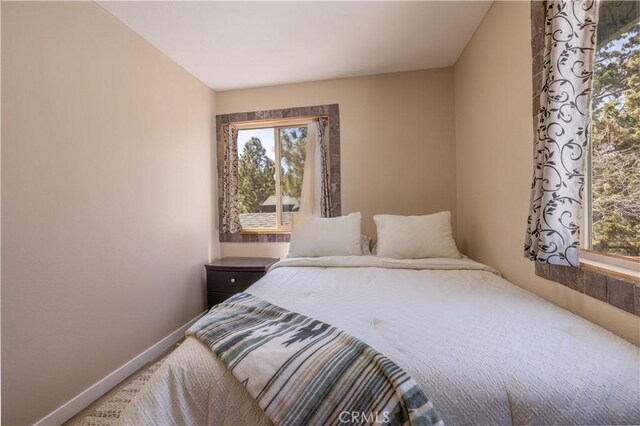 196 Sunset Ln, Sugarloaf, CA 92386 - bedroom with multiple windows and baseboards