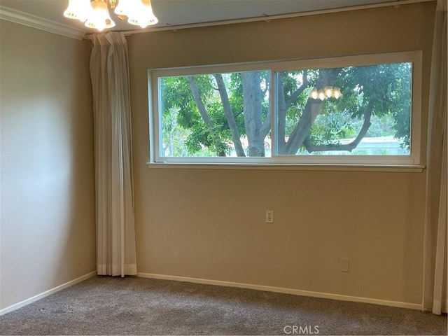 2370 Via Mariposa W Unit 1B, Laguna Woods, CA 92637 - unfurnished room featuring healthy amount of natural light, a chandelier, ornamental molding, and carpet floors