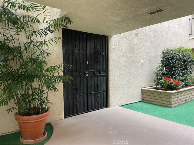 2370 Via Mariposa W Unit 1B, Laguna Woods, CA 92637 - doorway to property featuring stucco siding