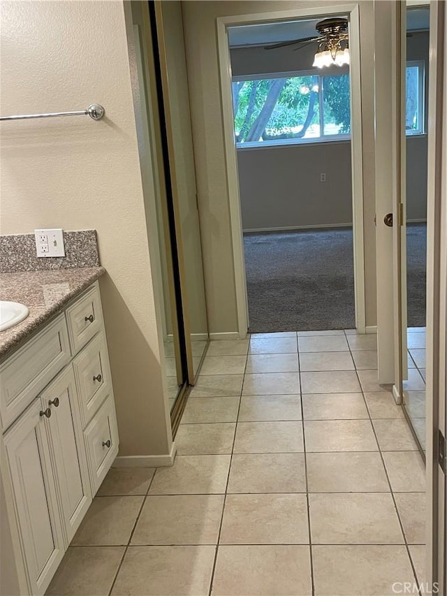 2370 Via Mariposa W Unit 1B, Laguna Woods, CA 92637 - bathroom with tile patterned floors, vanity, and a ceiling fan