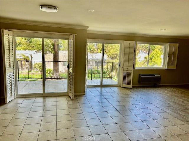 doorway to outside with baseboards, ornamental molding, a wealth of natural light, and light tile patterned floors