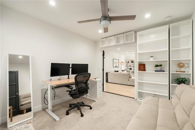 office space with baseboards, recessed lighting, a ceiling fan, and light colored carpet