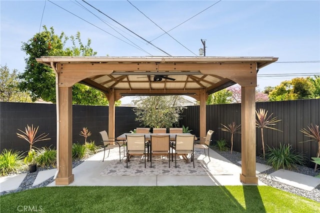 view of patio / terrace featuring a fenced backyard, a ceiling fan, and a gazebo