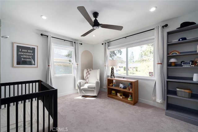 bedroom featuring recessed lighting, a nursery area, carpet, and baseboards