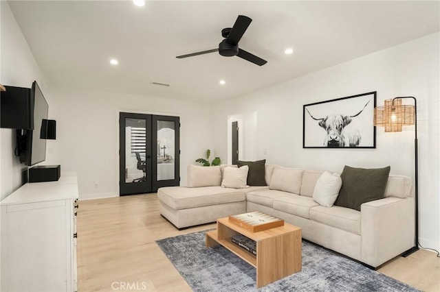 living room with recessed lighting, light wood-type flooring, a ceiling fan, and french doors