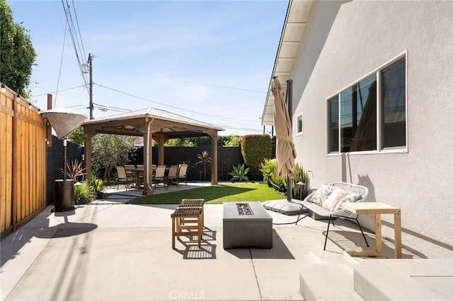 view of patio featuring a gazebo, a fenced backyard, and an outdoor fire pit