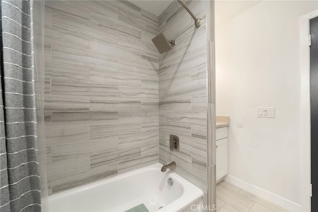 bathroom featuring vanity, baseboards, and shower / bathtub combination with curtain