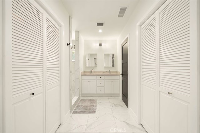 full bath featuring a closet, marble finish floor, a marble finish shower, and visible vents