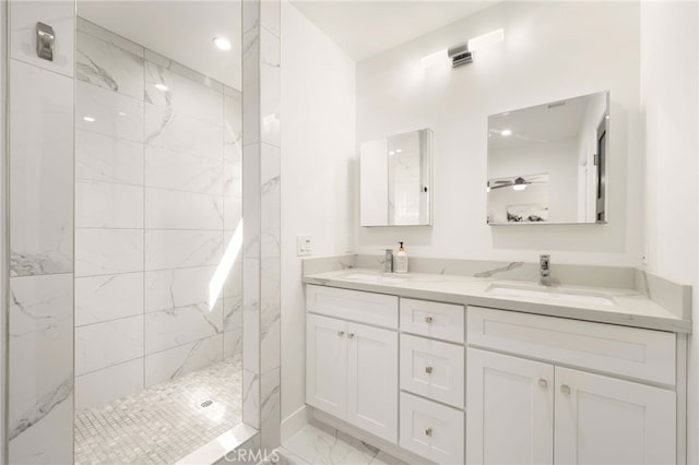 bathroom with double vanity, a marble finish shower, marble finish floor, and a sink