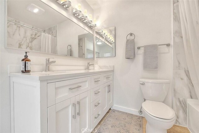4018 W 5th St Unit J, Santa Ana, CA 92703 - bathroom with a shower with curtain, a sink, double vanity, toilet, and baseboards
