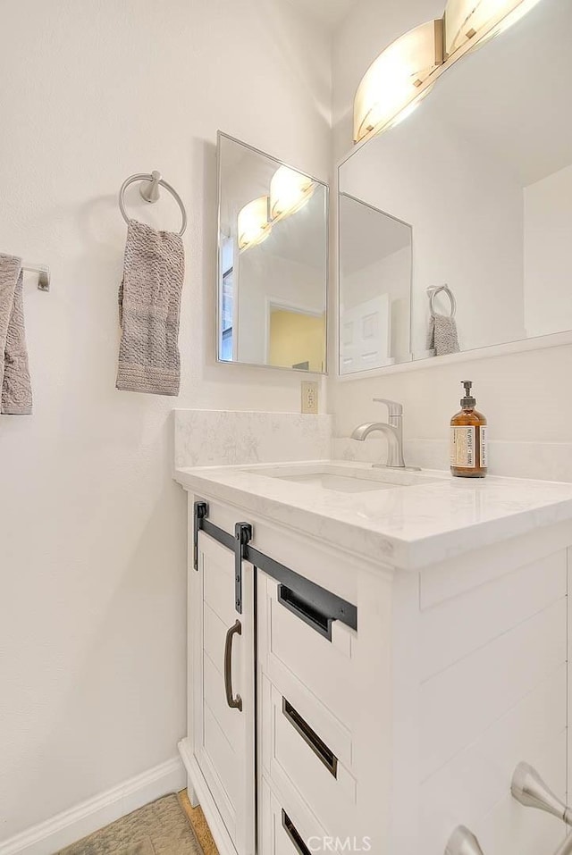 4018 W 5th St Unit J, Santa Ana, CA 92703 - bathroom featuring baseboards and vanity