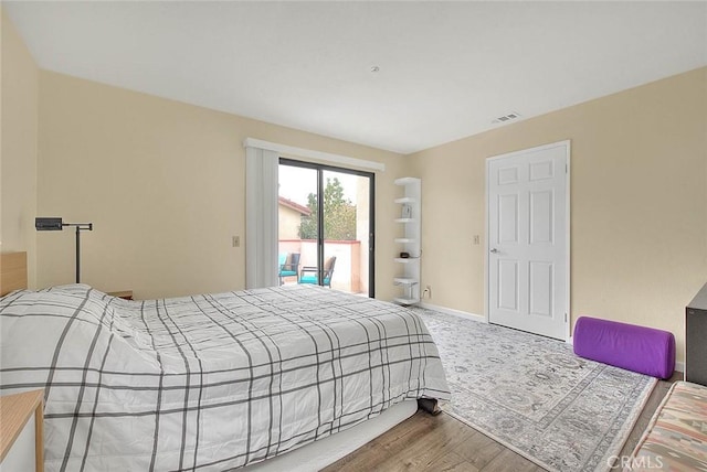 4018 W 5th St Unit J, Santa Ana, CA 92703 - bedroom with wood finished floors, visible vents, baseboards, and access to outside