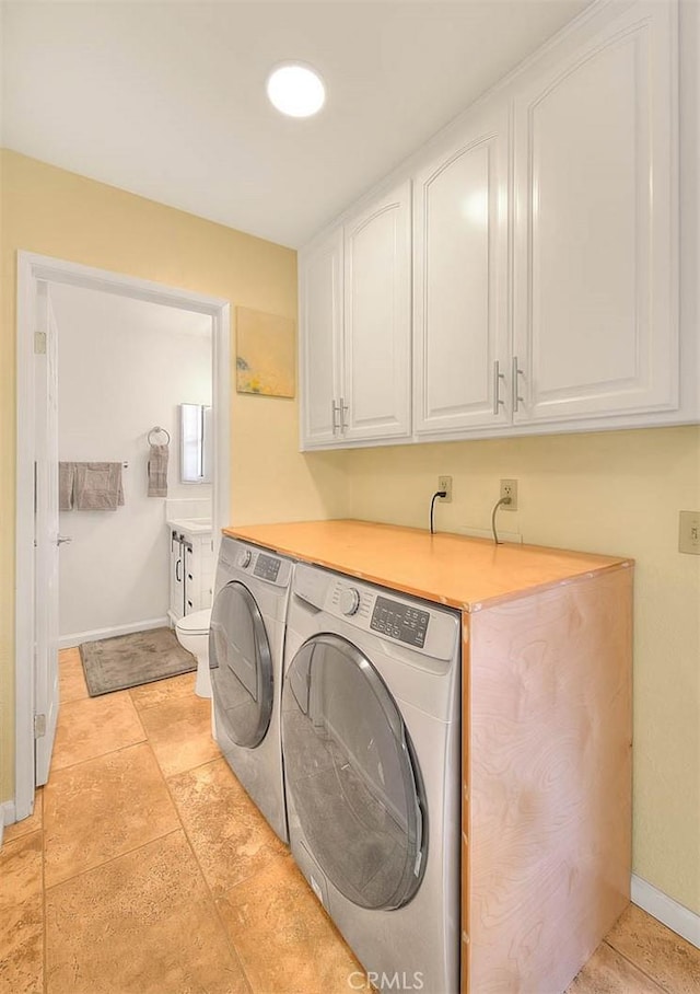4018 W 5th St Unit J, Santa Ana, CA 92703 - laundry area with washing machine and dryer, baseboards, and cabinet space