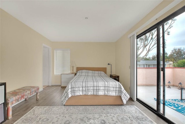 4018 W 5th St Unit J, Santa Ana, CA 92703 - bedroom with light wood-style flooring, baseboards, and access to outside