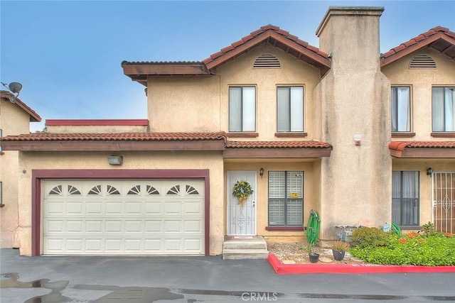 4018 W 5th St Unit J, Santa Ana, CA 92703 - view of front of property featuring driveway, a tiled roof, and stucco siding