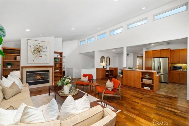 2377 Silver Ridge Ave, Los Angeles, CA 90039 - living area with wood finished floors, recessed lighting, a tiled fireplace, and a towering ceiling