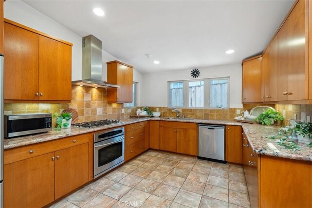 2377 Silver Ridge Ave, Los Angeles, CA 90039 - kitchen with stainless steel appliances, wall chimney range hood, tasteful backsplash, brown cabinetry, and recessed lighting