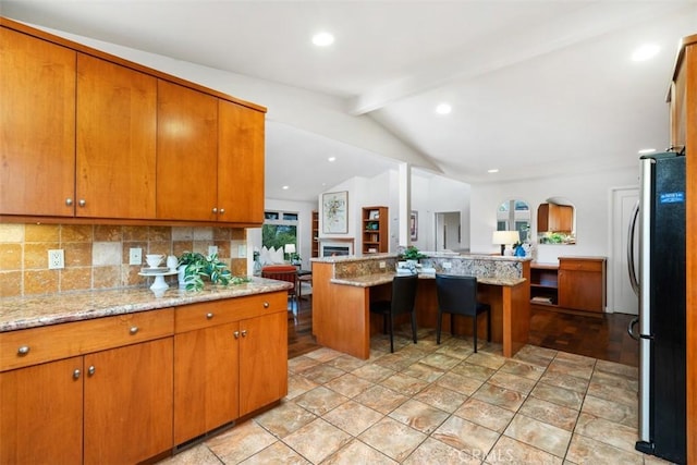 2377 Silver Ridge Ave, Los Angeles, CA 90039 - kitchen featuring freestanding refrigerator, open floor plan, backsplash, brown cabinetry, and recessed lighting
