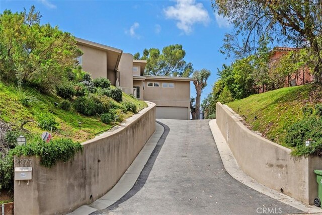 2377 Silver Ridge Ave, Los Angeles, CA 90039 - view of property exterior with a garage, asphalt driveway, and stucco siding