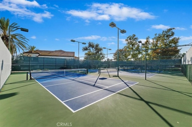 view of sport court with fence