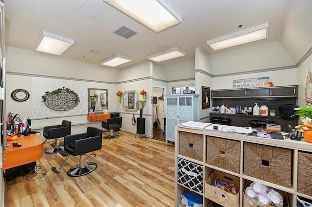 interior space featuring visible vents, wood finished floors, and lofted ceiling