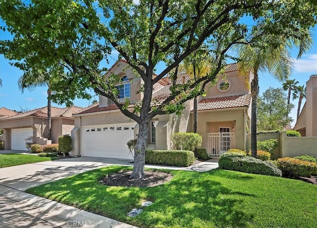 view of front of home featuring a tiled roof, fence, stucco siding, concrete driveway, and a front yard