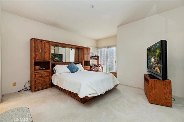 bedroom featuring light colored carpet