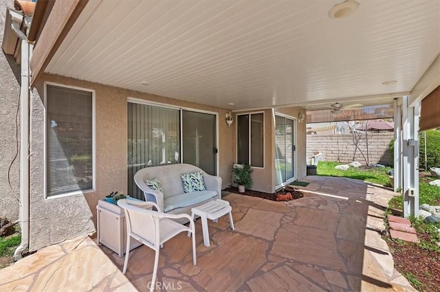view of patio / terrace featuring a ceiling fan and fence