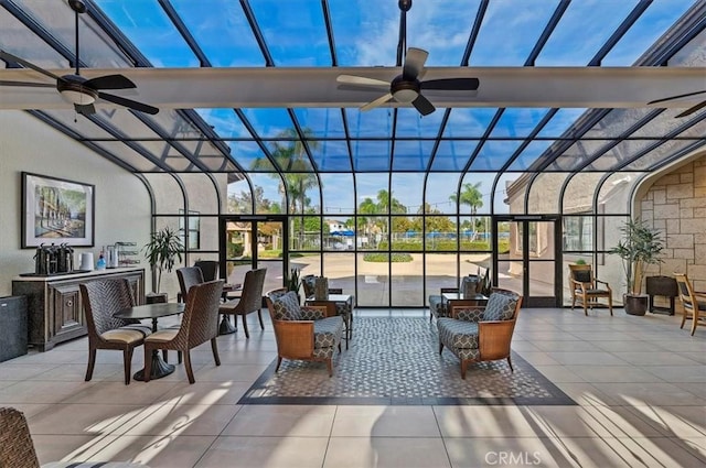 sunroom / solarium featuring a healthy amount of sunlight and ceiling fan