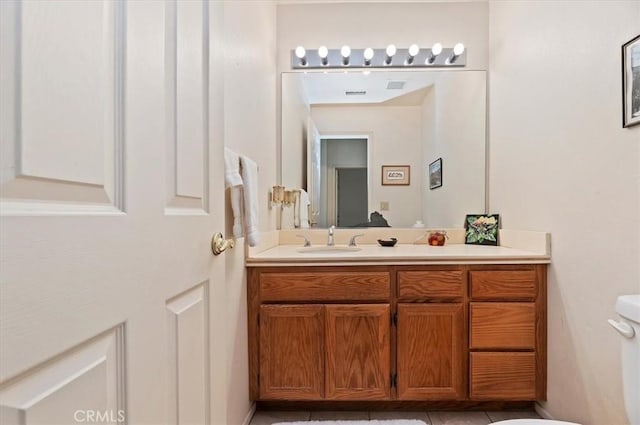 bathroom featuring tile patterned floors, toilet, visible vents, and vanity