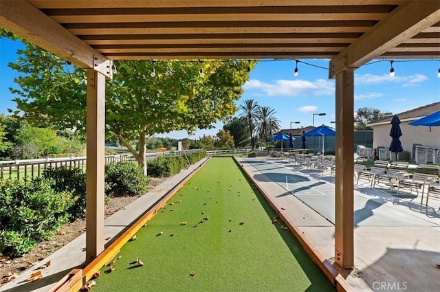 surrounding community with shuffleboard and fence