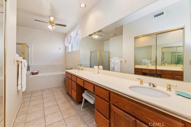 bathroom featuring a stall shower, a sink, visible vents, tile patterned flooring, and ceiling fan