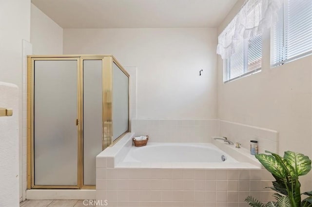 full bathroom featuring a stall shower and a bath