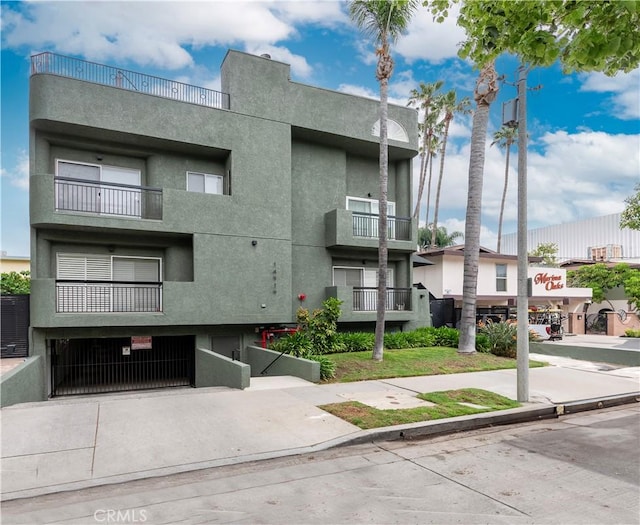 14919 Dickens St Unit 104, Sherman Oaks, CA 91403 - view of building exterior with driveway and a garage
